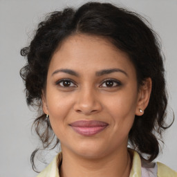 Joyful black young-adult female with medium  brown hair and brown eyes