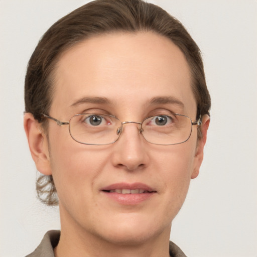 Joyful white adult female with short  brown hair and grey eyes