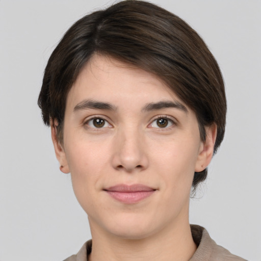 Joyful white young-adult female with short  brown hair and brown eyes