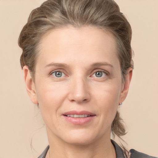 Joyful white adult female with short  brown hair and grey eyes