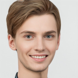 Joyful white young-adult male with short  brown hair and grey eyes