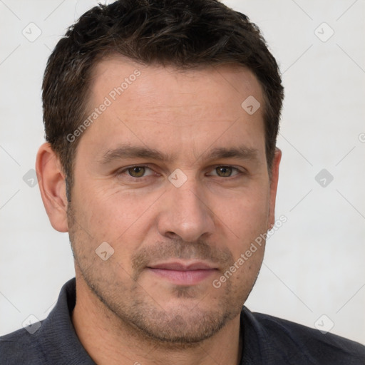 Joyful white adult male with short  brown hair and brown eyes