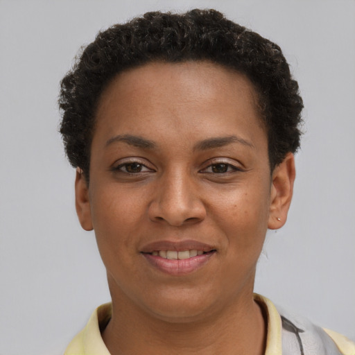 Joyful black young-adult female with short  brown hair and brown eyes