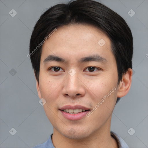 Joyful asian young-adult male with short  black hair and brown eyes