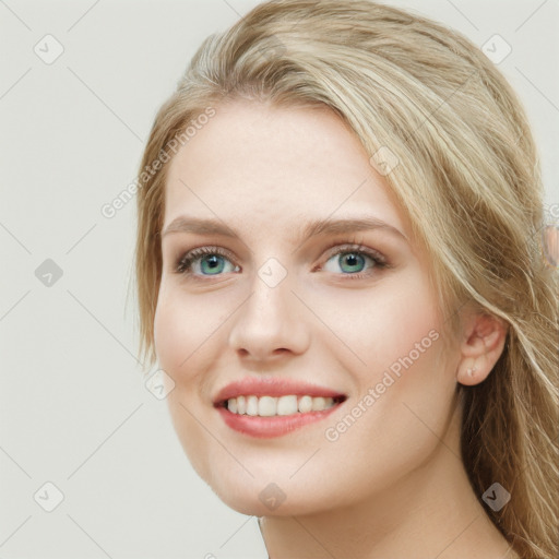 Joyful white young-adult female with long  brown hair and blue eyes