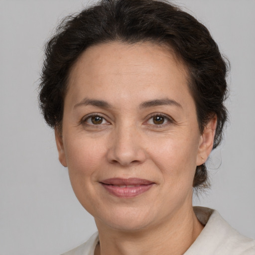 Joyful white adult female with short  brown hair and brown eyes