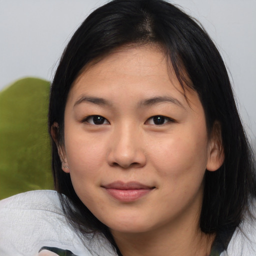 Joyful asian young-adult female with medium  black hair and brown eyes