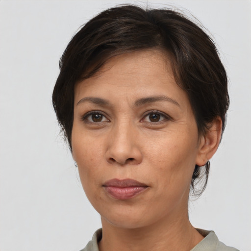 Joyful asian adult female with short  brown hair and brown eyes