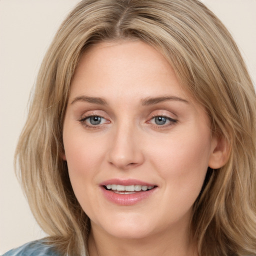 Joyful white young-adult female with medium  brown hair and blue eyes