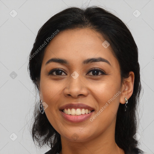 Joyful latino young-adult female with long  black hair and brown eyes