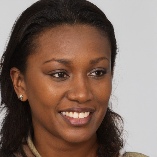 Joyful black young-adult female with long  brown hair and brown eyes