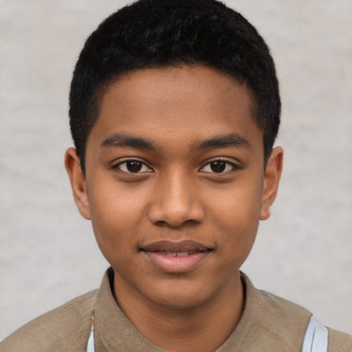 Joyful black child male with short  black hair and brown eyes