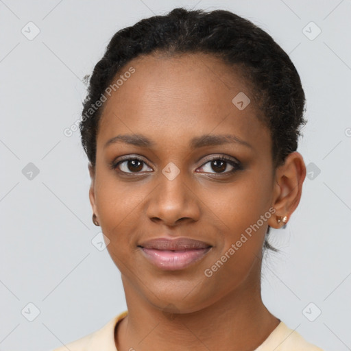 Joyful black young-adult female with short  brown hair and brown eyes