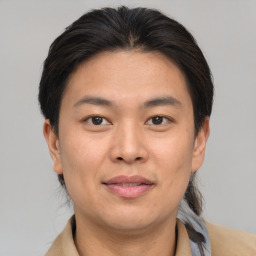 Joyful asian young-adult male with short  brown hair and brown eyes