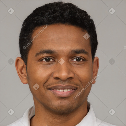 Joyful black young-adult male with short  black hair and brown eyes