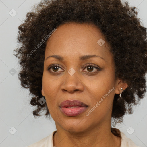 Joyful black adult female with medium  brown hair and brown eyes