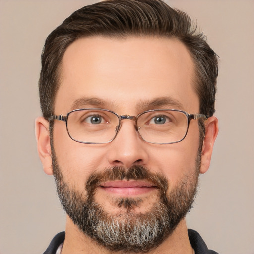 Joyful white adult male with short  brown hair and brown eyes