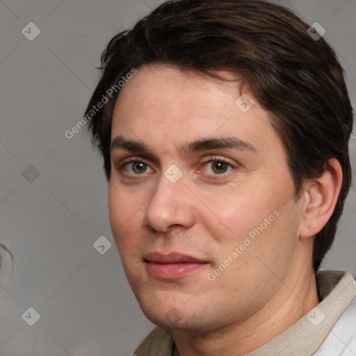 Joyful white adult male with short  brown hair and brown eyes