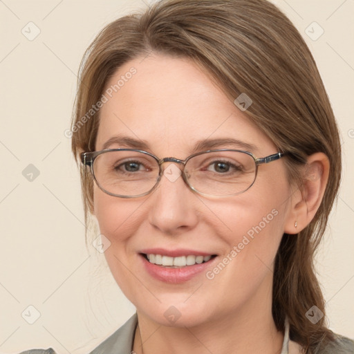 Joyful white adult female with medium  brown hair and blue eyes