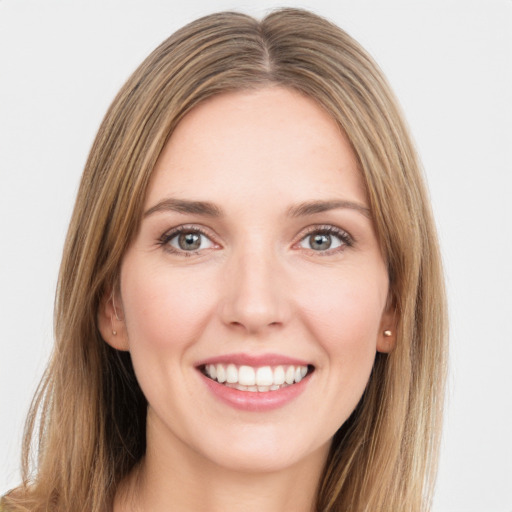 Joyful white young-adult female with long  brown hair and green eyes