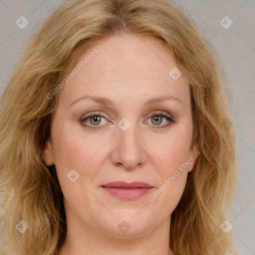 Joyful white adult female with long  brown hair and green eyes