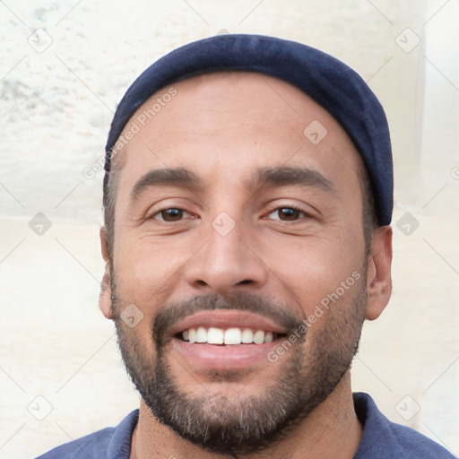 Joyful white young-adult male with short  black hair and brown eyes