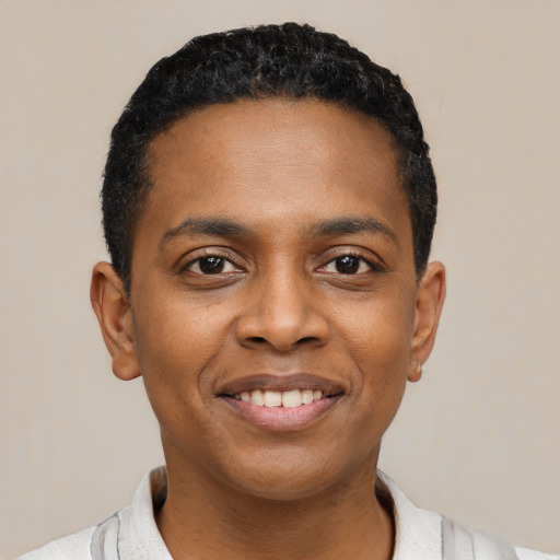 Joyful black young-adult male with short  black hair and brown eyes