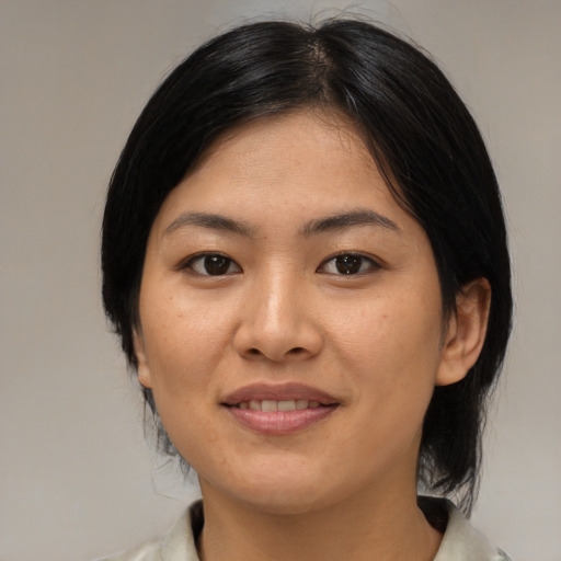 Joyful asian young-adult female with medium  black hair and brown eyes