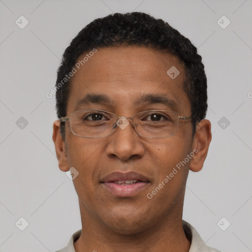 Joyful black adult male with short  black hair and brown eyes
