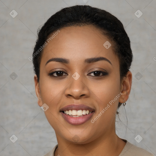 Joyful black young-adult female with short  black hair and brown eyes