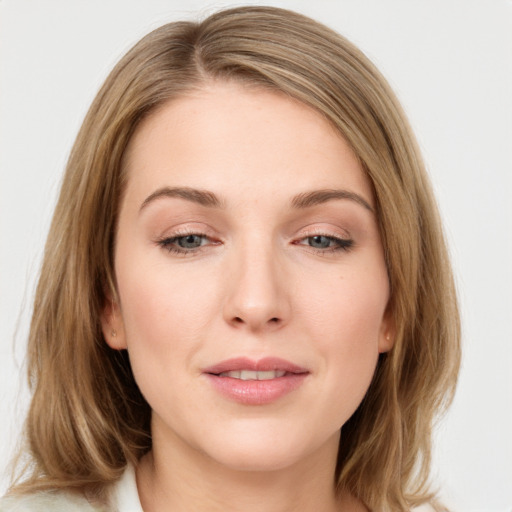 Joyful white young-adult female with medium  brown hair and blue eyes