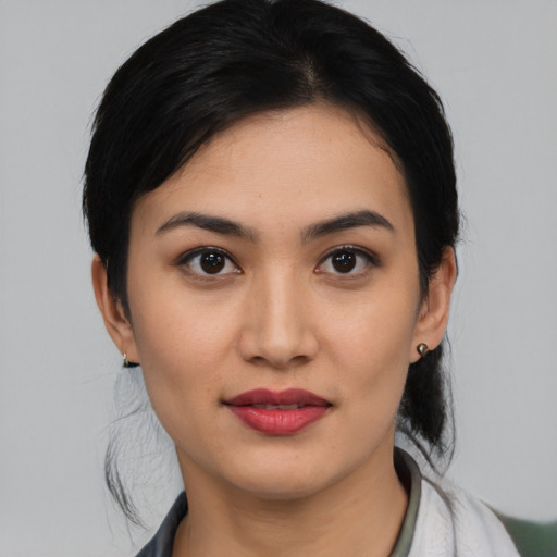 Joyful latino young-adult female with medium  black hair and brown eyes