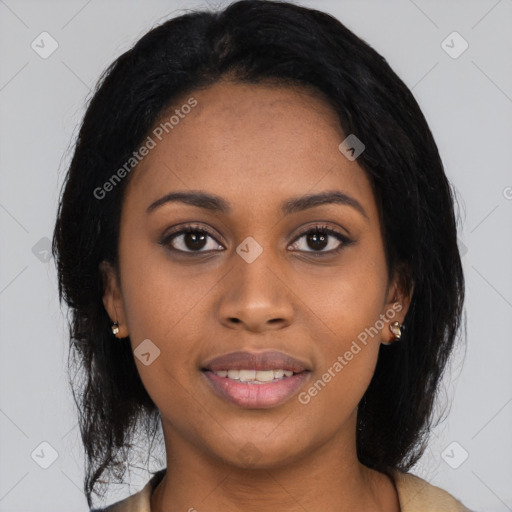 Joyful black young-adult female with long  black hair and brown eyes