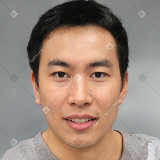 Joyful asian young-adult male with short  black hair and brown eyes