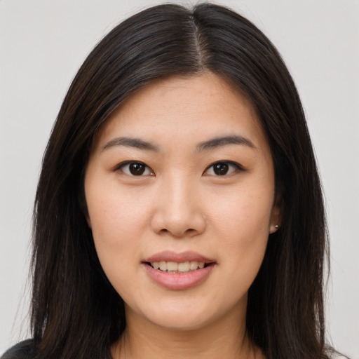 Joyful asian young-adult female with long  brown hair and brown eyes