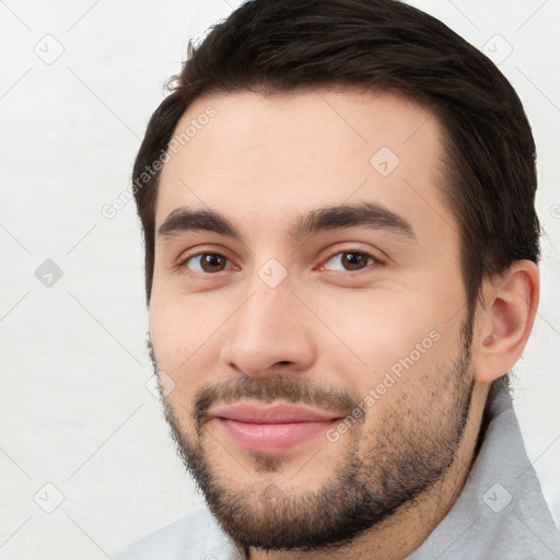 Joyful white young-adult male with short  brown hair and brown eyes