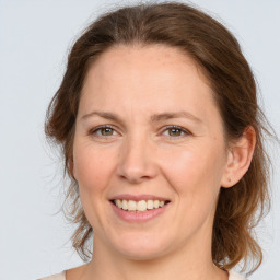 Joyful white adult female with medium  brown hair and grey eyes