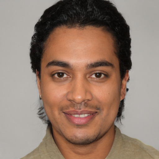 Joyful latino young-adult male with short  black hair and brown eyes