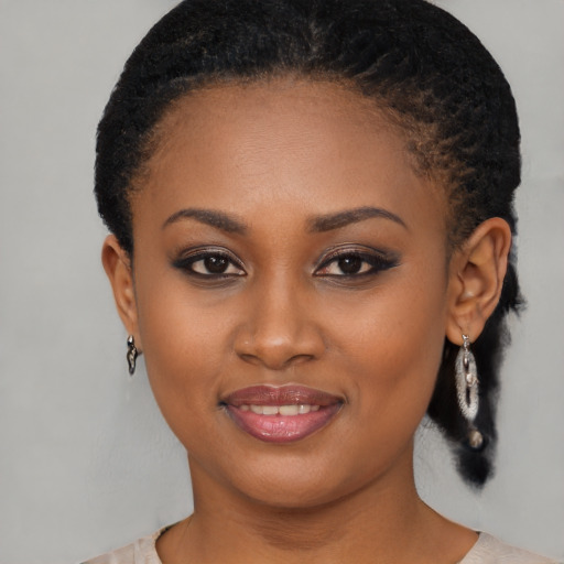 Joyful black young-adult female with medium  brown hair and brown eyes