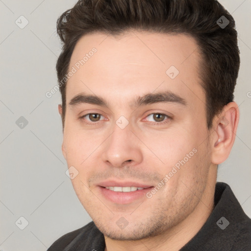 Joyful white young-adult male with short  brown hair and brown eyes