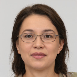 Joyful white adult female with medium  brown hair and grey eyes