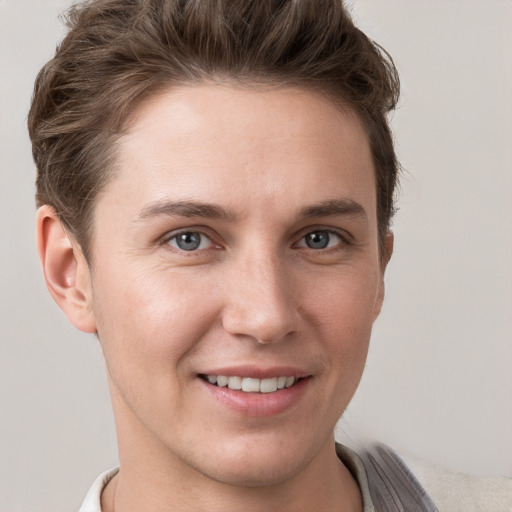 Joyful white young-adult female with short  brown hair and grey eyes