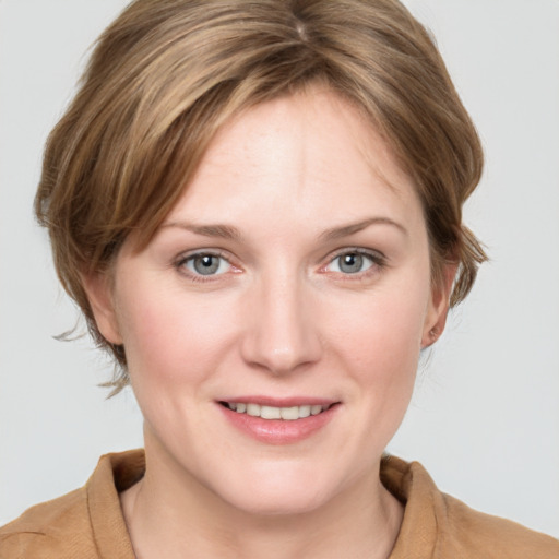 Joyful white young-adult female with medium  brown hair and blue eyes