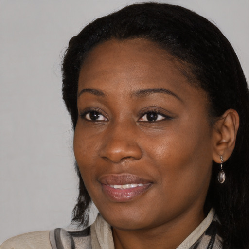 Joyful black young-adult female with medium  black hair and brown eyes