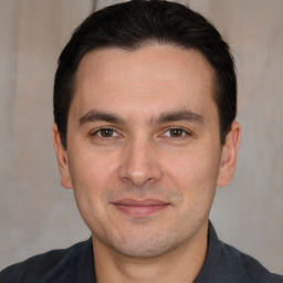 Joyful white adult male with short  brown hair and brown eyes