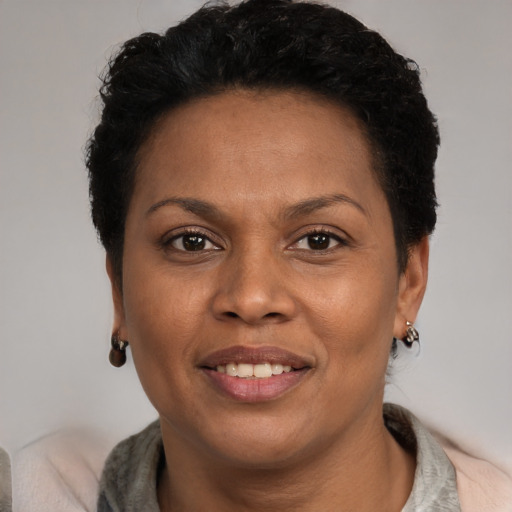 Joyful black adult female with short  brown hair and brown eyes
