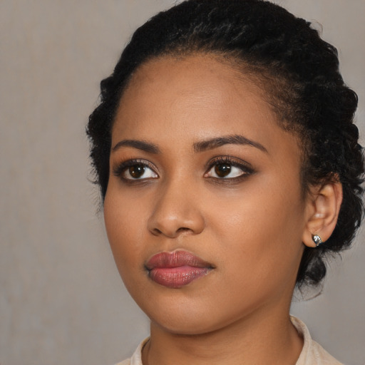 Neutral black young-adult female with medium  black hair and brown eyes