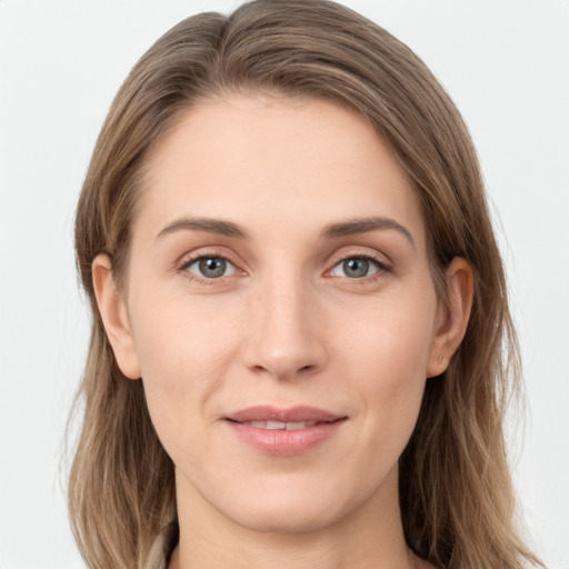 Joyful white young-adult female with long  brown hair and grey eyes