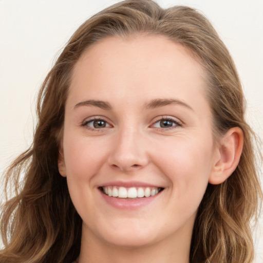 Joyful white young-adult female with long  brown hair and blue eyes