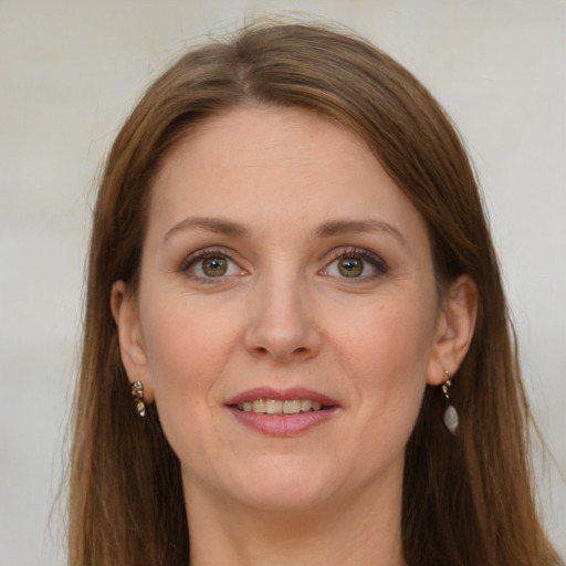 Joyful white young-adult female with long  brown hair and grey eyes